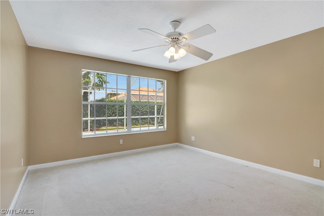5682 Eleuthera Way Naples, FL 34119 - Photo 11 of 47 an empty room with windows and fan