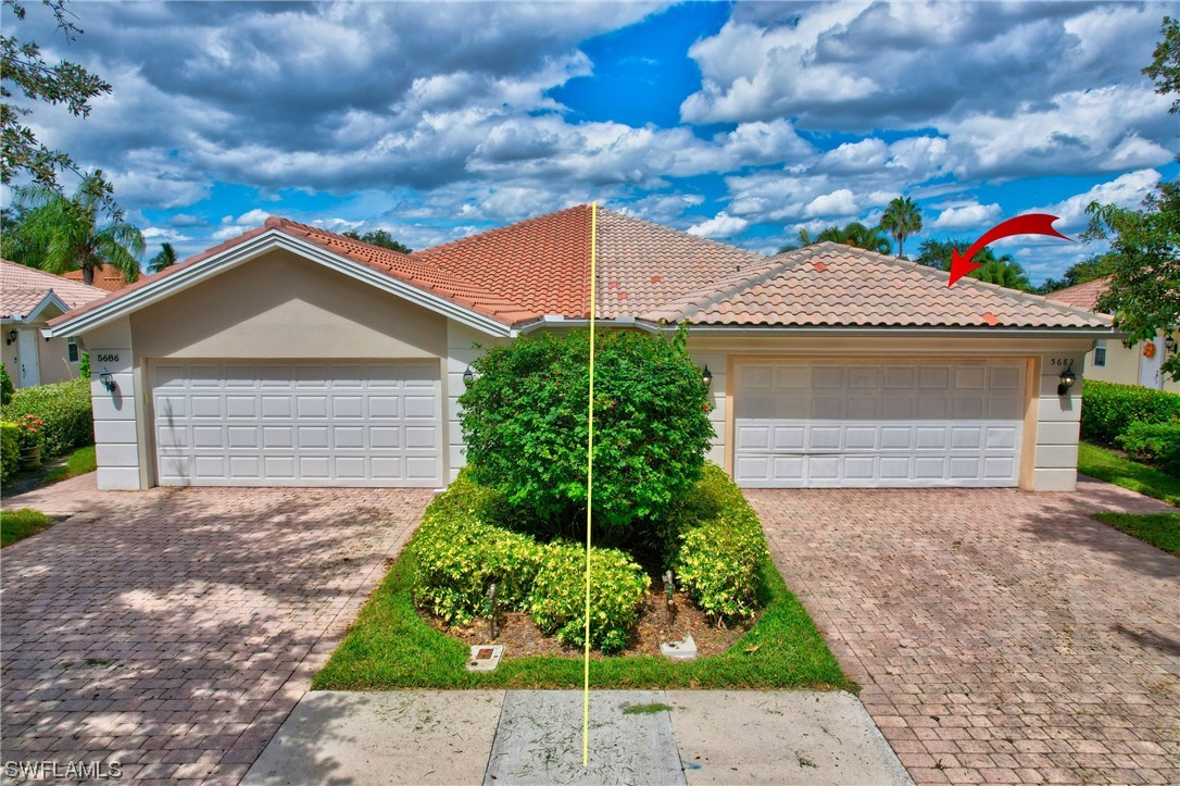 5682 Eleuthera Way Naples, FL 34119 - Photo 24 of 47 a front view of a house with a garden