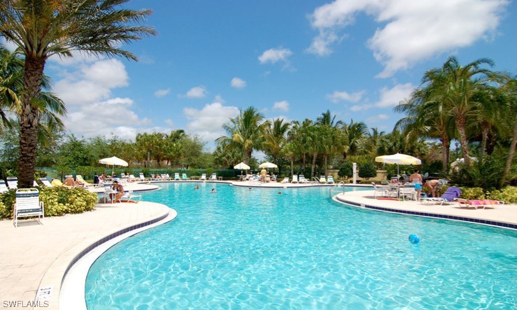 5682 Eleuthera Way Naples, FL 34119 - Photo 30 of 47 a view of a swimming pool and outdoor seating