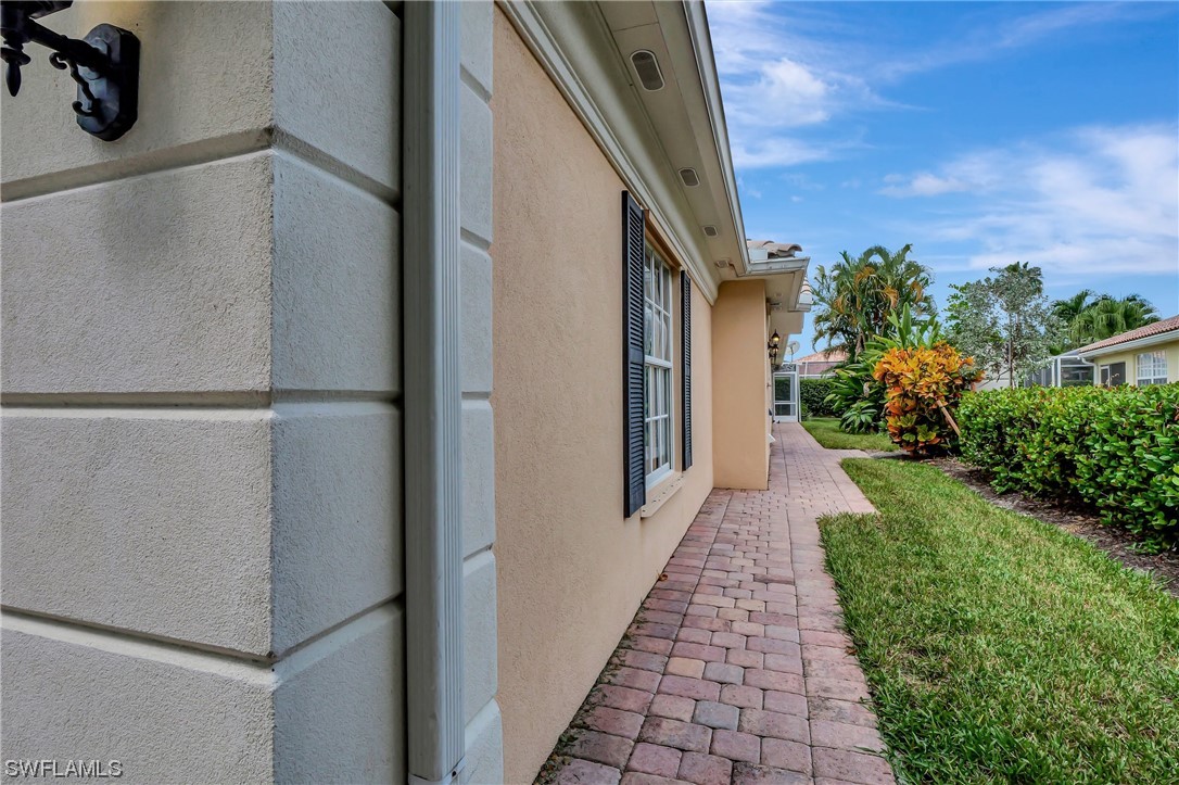 5682 Eleuthera Way Naples, FL 34119 - Photo 3 of 47 a view of a pathway of a house with backyard