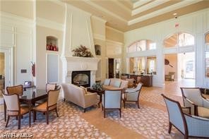 5682 Eleuthera Way Naples, FL 34119 - Photo 35 of 47 a living room with furniture a fireplace and a large window