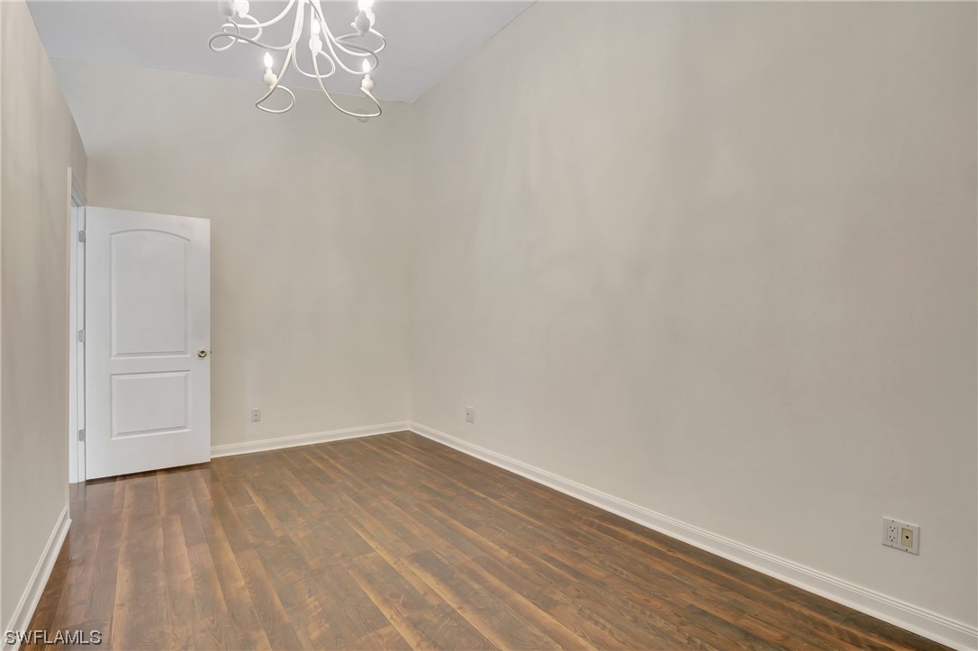 5682 Eleuthera Way Naples, FL 34119 - Photo 4 of 47 a view of empty room with wooden floor