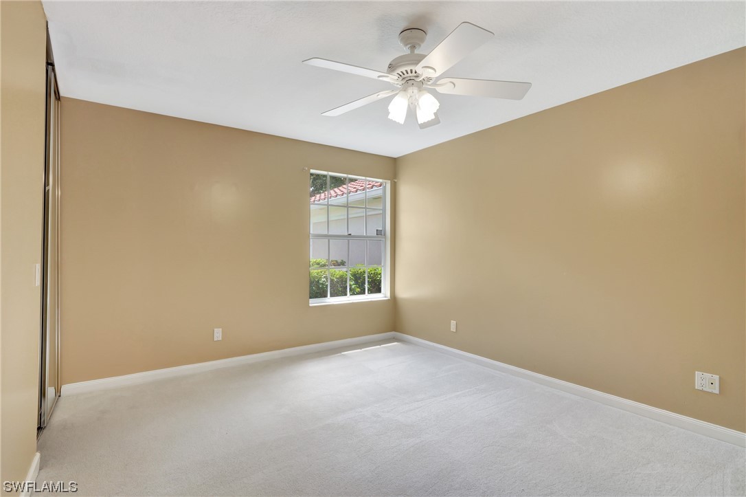 5682 Eleuthera Way Naples, FL 34119 - Photo 5 of 47 an empty room with windows and fan
