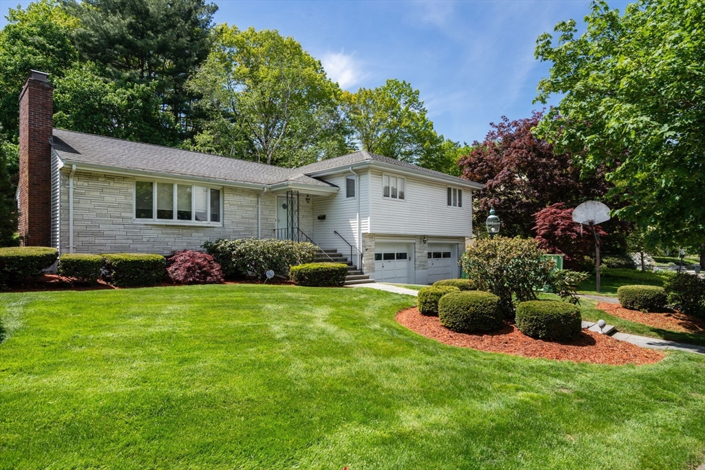 a front view of a house with a garden