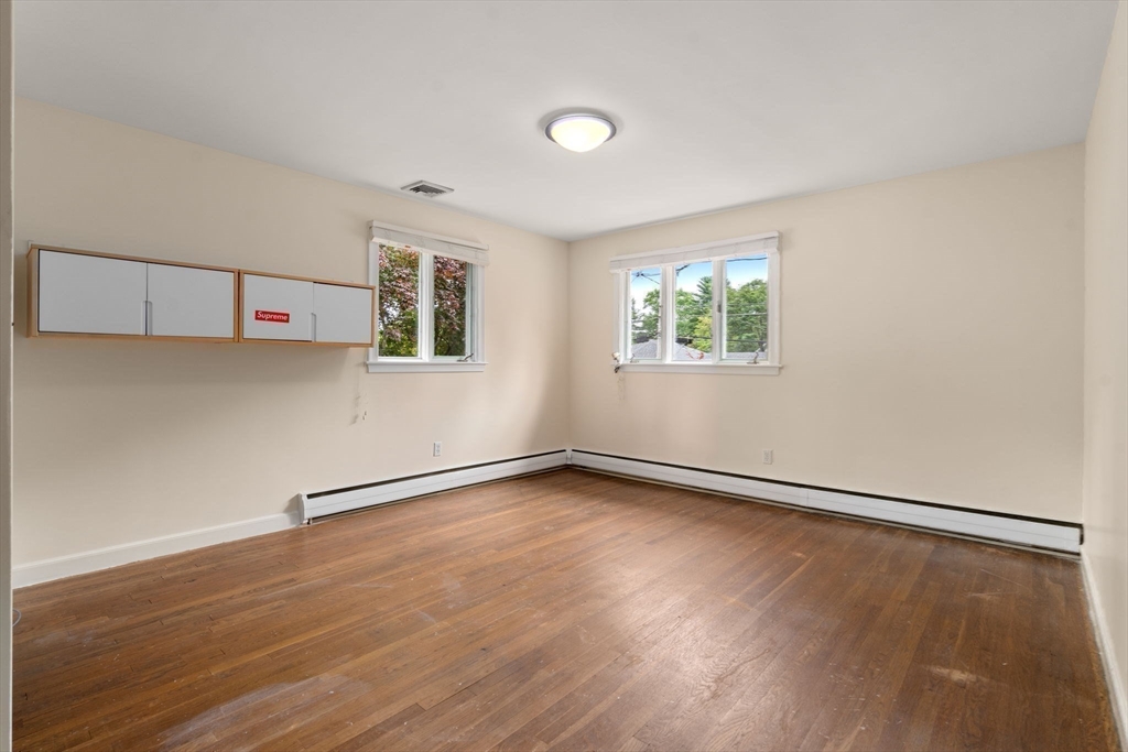 61 Sevland Road Newton, MA 02459 - Photo 13 of 27 an empty room with wooden floor and windows