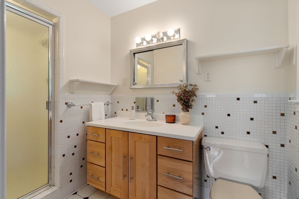 61 Sevland Road Newton, MA 02459 - Photo 15 of 27 a bathroom with a sink vanity mirror and toilet