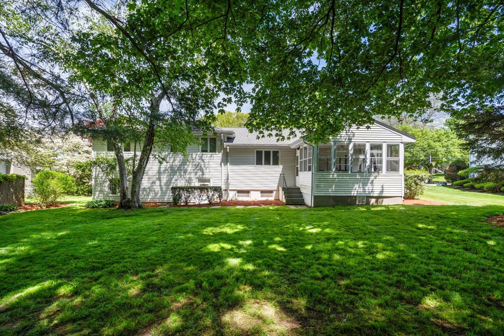 61 Sevland Road Newton, MA 02459 - Photo 25 of 27 a front view of a house with a garden and trees