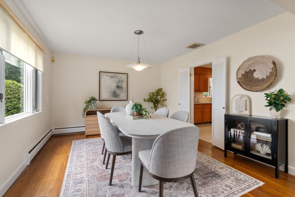61 Sevland Road Newton, MA 02459 - Photo 6 of 27 a view of a dining room with furniture and a fireplace