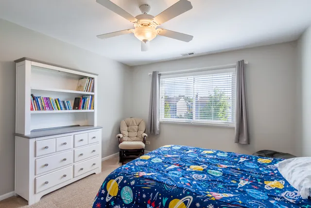 a bedroom with a bed and a dresser in it