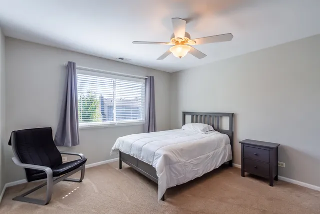 a bedroom with a bed and a chair