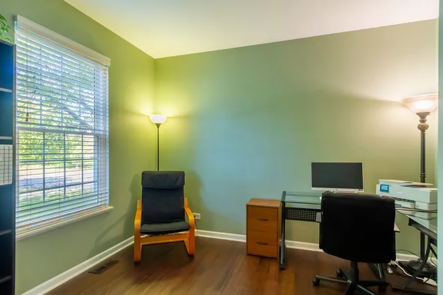 a view of workspace with wooden floor windows