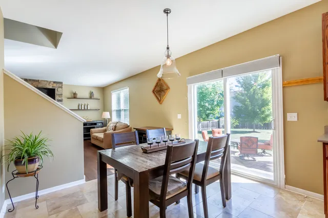 a dining room with furniture window and outdoor view