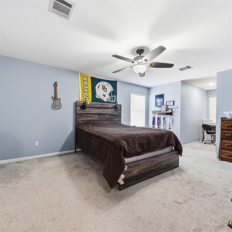 785 Tweedy Road Valley Mills, TX 76689 - Photo 23 of 40 Bedroom featuring light-colored carpet flooring and light blue wall tones