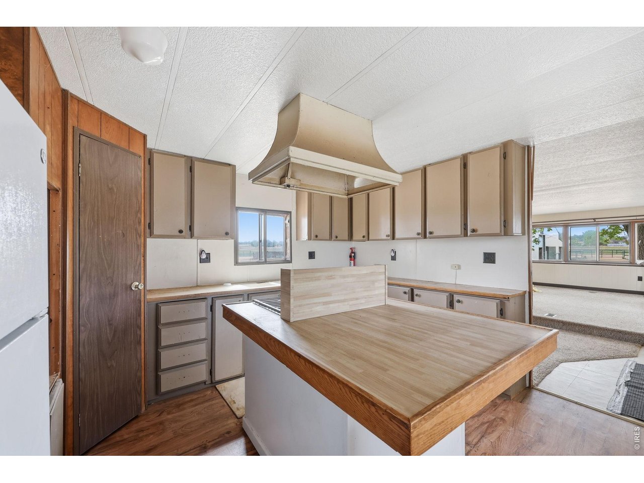 11098 Jasper Road Lafayette, CO 80026 - Photo 45 of 50 a kitchen with kitchen island a counter top space a sink stainless steel appliances and cabinets
