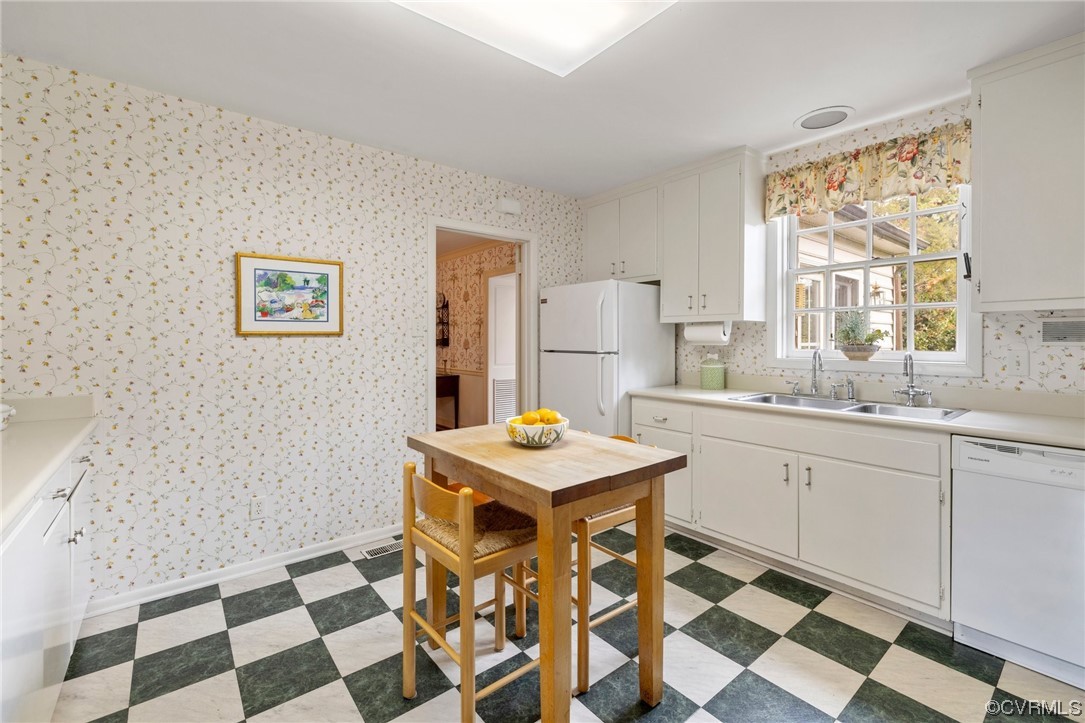 6161 River Road, Unit 1 Richmond, VA 23226 - Photo 17 of 32 a kitchen with a checkered floor and white cabinets