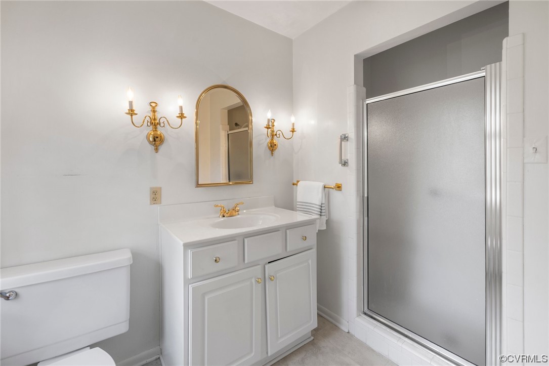 6161 River Road, Unit 1 Richmond, VA 23226 - Photo 22 of 32 a bathroom with a sink a toilet and a mirror