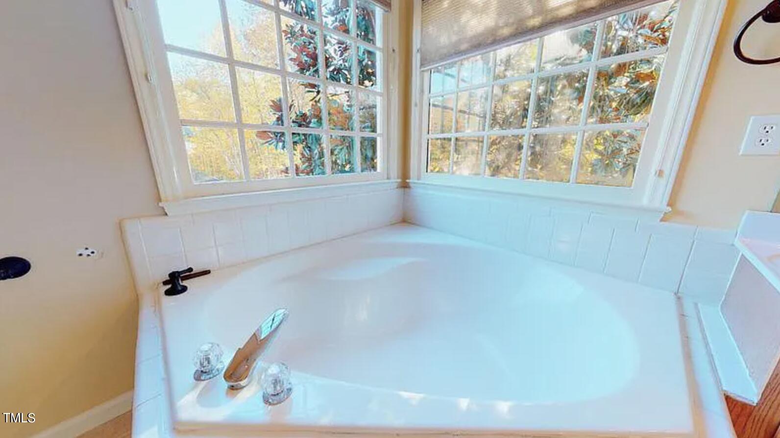 2604 Crofton Springs Drive Raleigh, NC 27615 - Photo 14 of 21 a bath tub sitting in a bathroom next to a window