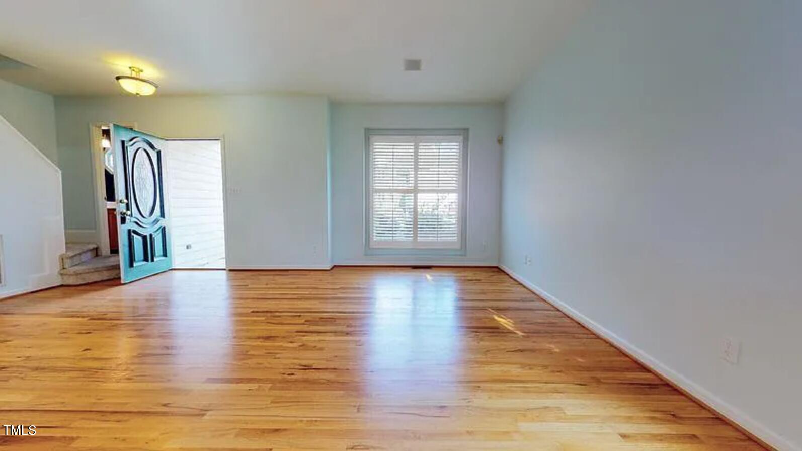 2604 Crofton Springs Drive Raleigh, NC 27615 - Photo 5 of 21 a view of empty room with wooden floor and fan