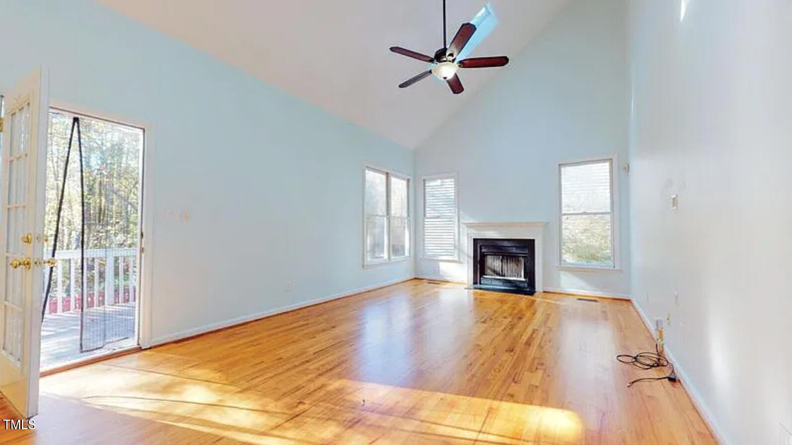 2604 Crofton Springs Drive Raleigh, NC 27615 - Photo 9 of 21 a view of a livingroom with a fireplace a ceiling fan and windows