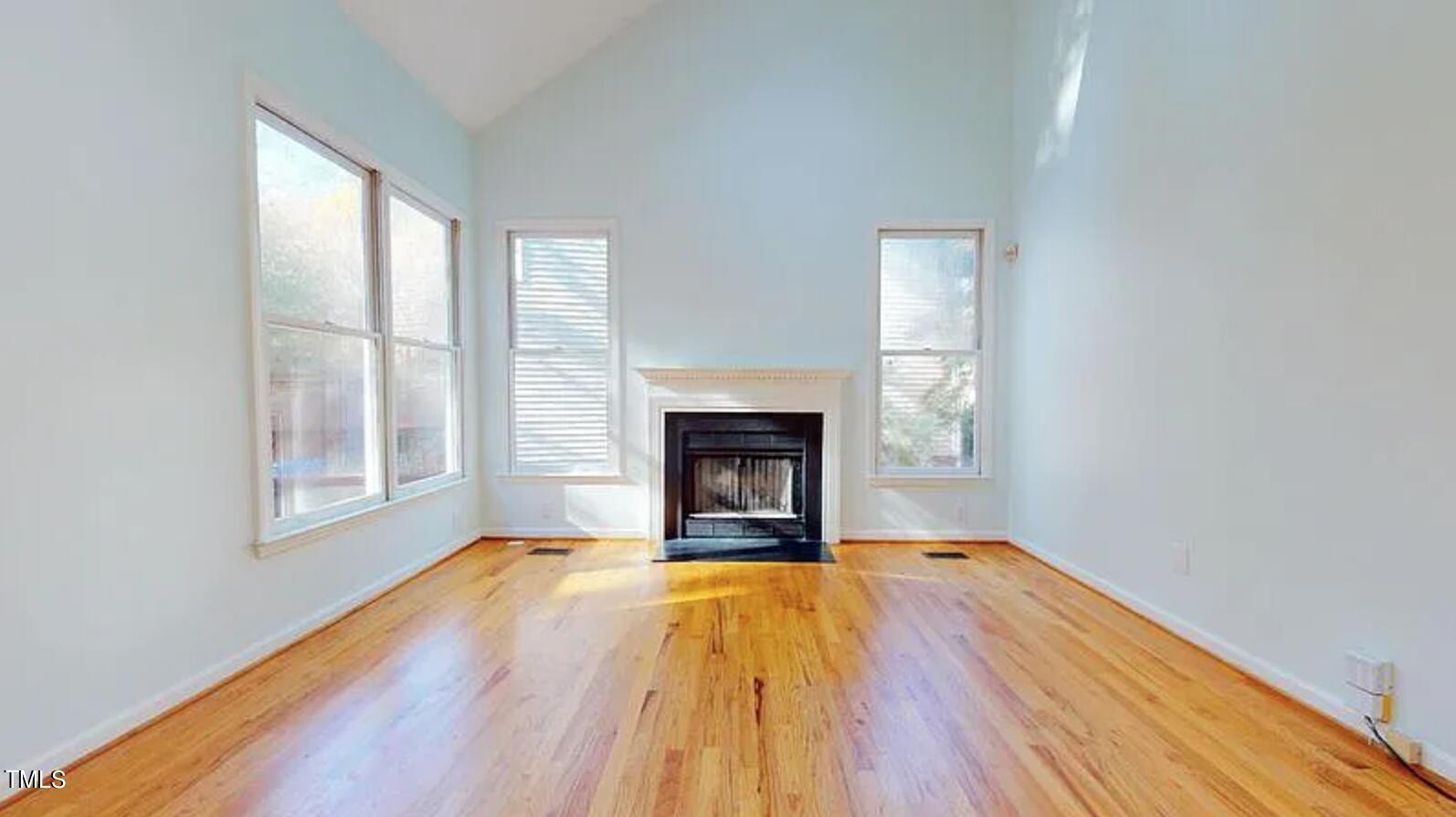 2604 Crofton Springs Drive Raleigh, NC 27615 - Photo 10 of 21 a view of an empty room with a window and wooden floor