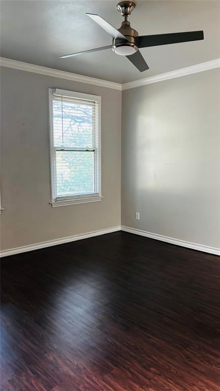 4511 Junius Street Dallas, TX 75246 - Photo 12 of 16 Room featuring dark wood-finish flooring, light-toned walls, and white crown molding
