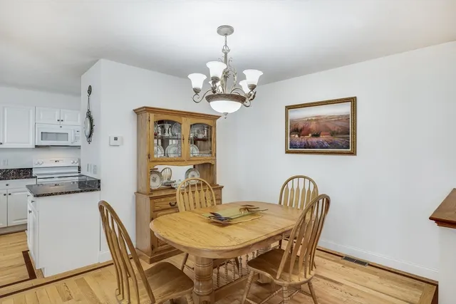 a view of a dining room with furniture and chandelier