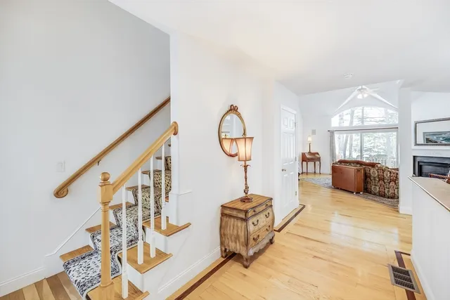 a living room with furniture a rug and a chandelier