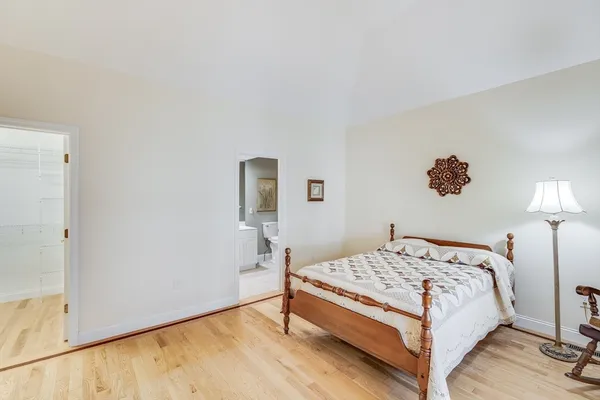 a bedroom with a bed and a lamp on table