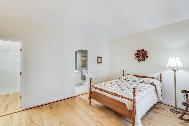 a bedroom with a bed and a lamp on table