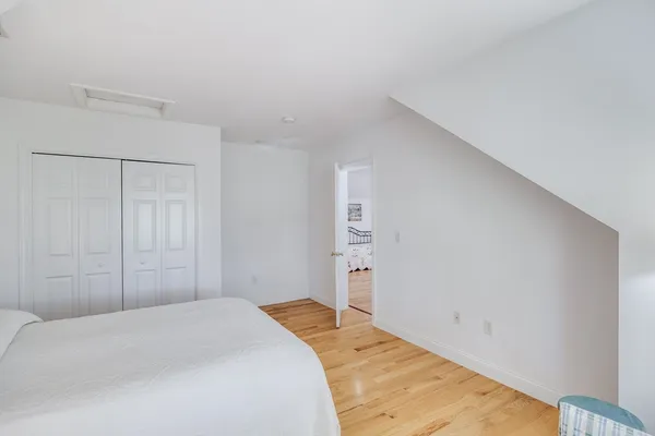 a bedroom with a bed and a closet