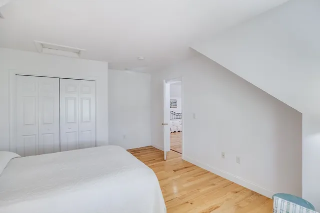 a bedroom with a bed and a closet