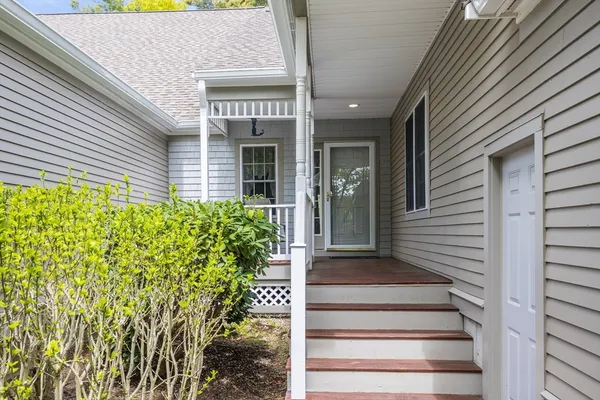 a front view of a house with plants