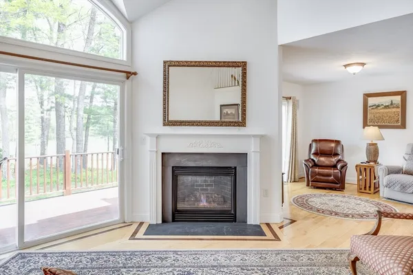 a living room with furniture a window and a fireplace