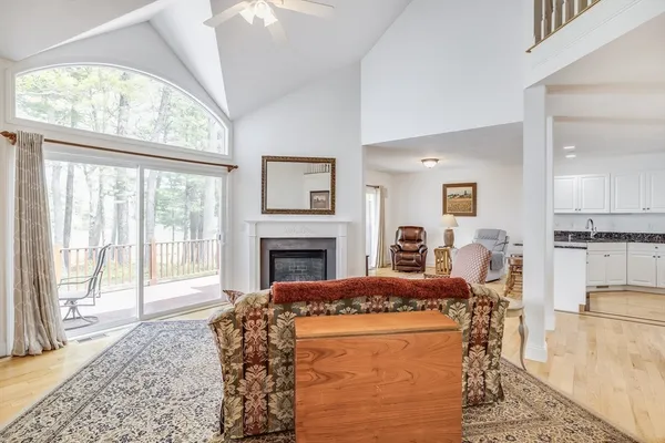 a living room with furniture a fireplace and a table
