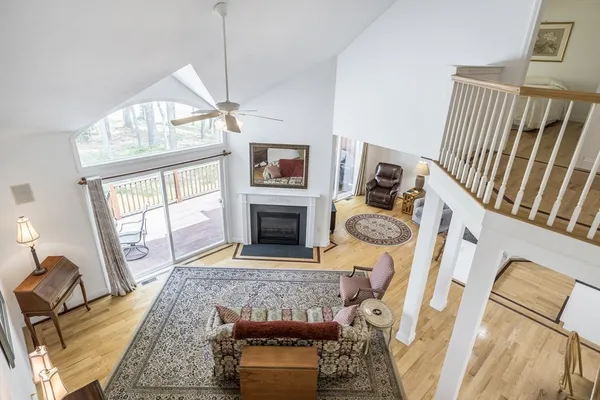 a living room with furniture a fireplace and a chandelier