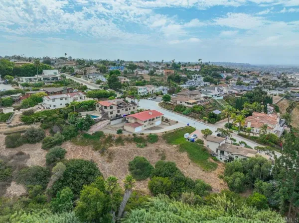 an aerial view of residential houses with city view