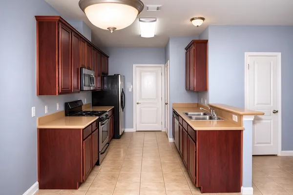 a kitchen with a stove sink and a refrigerator