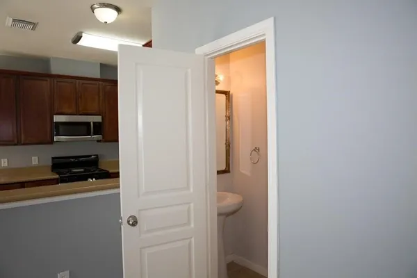 a kitchen with a refrigerator and a stove top oven