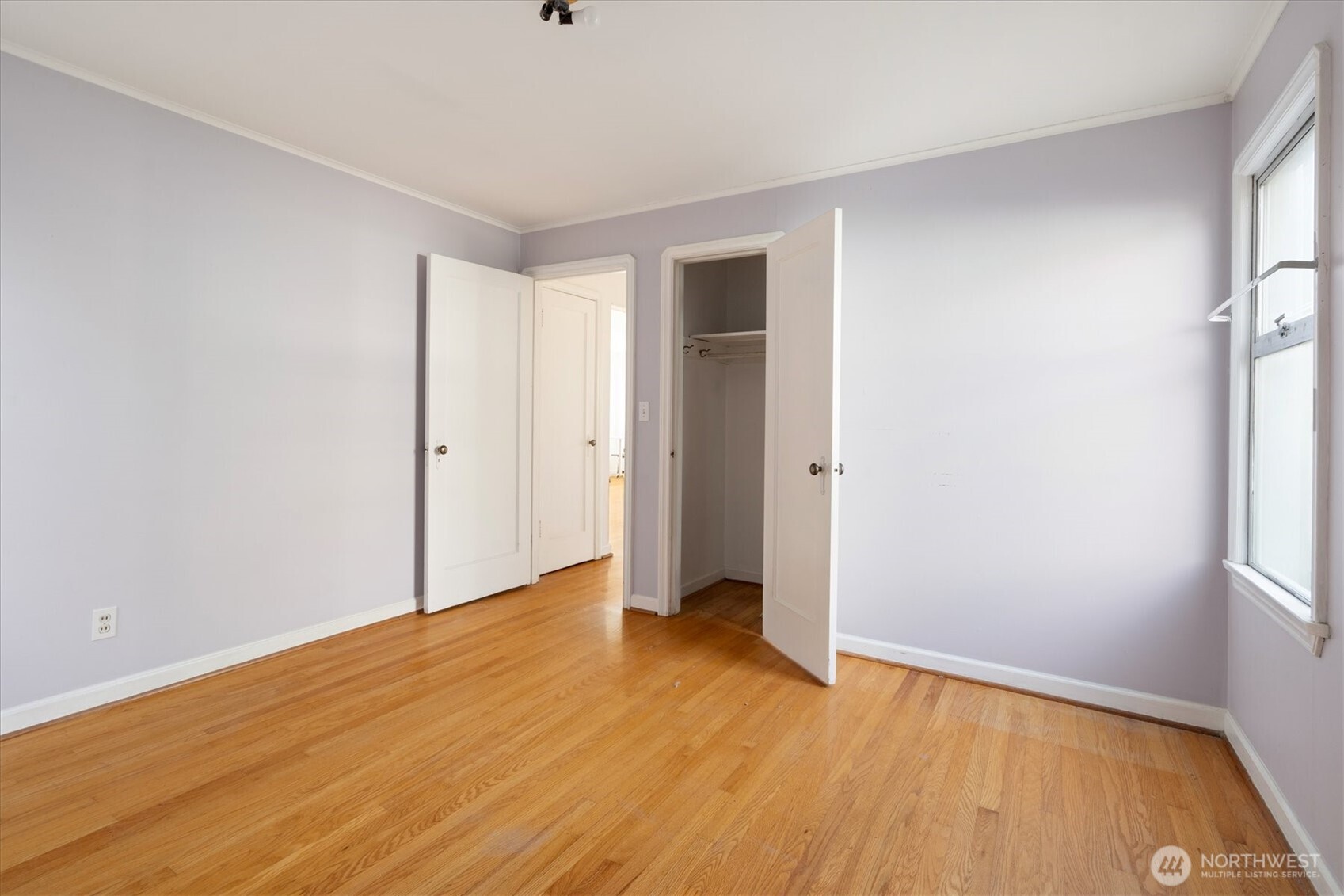 7542 9th Avenue Northwest Seattle, WA 98117 - Photo 12 of 26 an empty room with wooden floor and a window