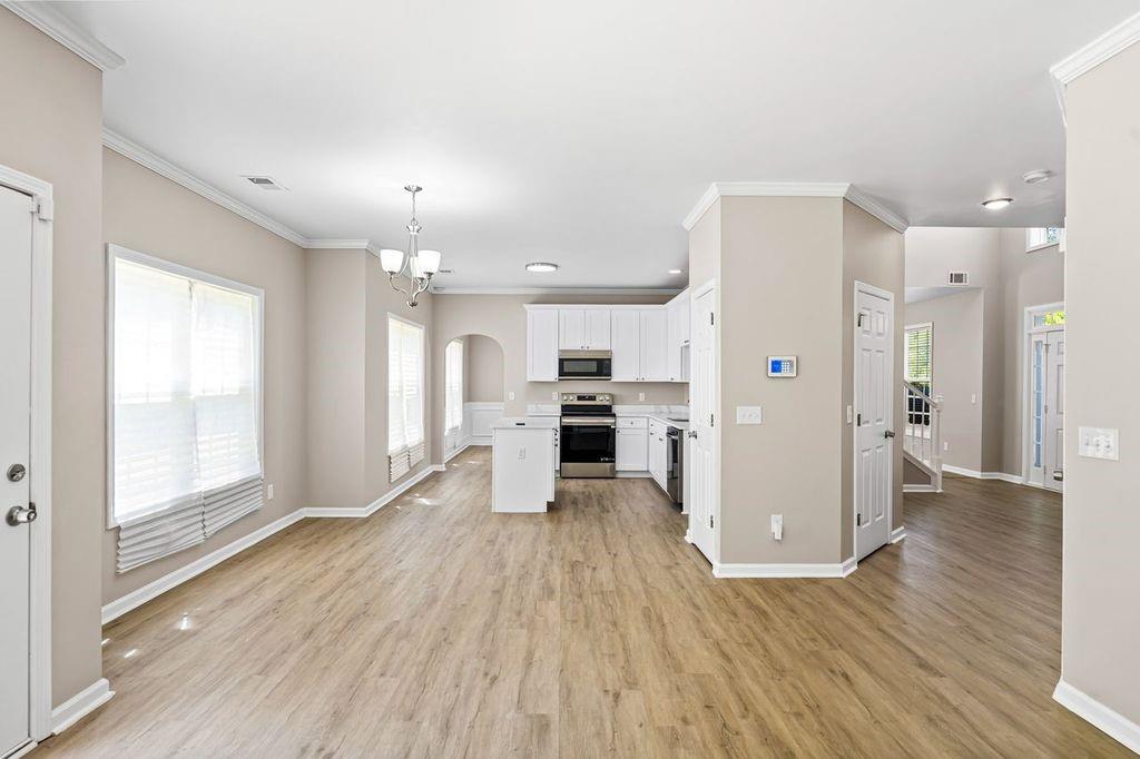 473 Greyhawk Way Fairburn, GA 30213 - Photo 15 of 34 a view of kitchen with furniture and wooden floor