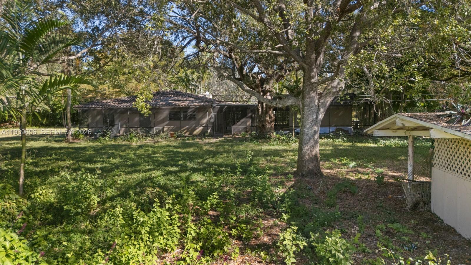 13500 Southwest 68th Court Pinecrest, FL 33156 - Photo 12 of 21 a backyard of a house with lots of green space