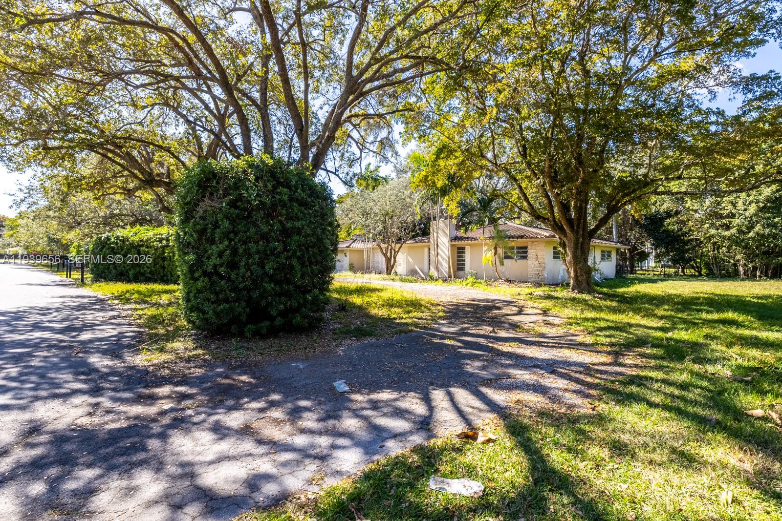 13500 Southwest 68th Court Pinecrest, FL 33156 - Photo 8 of 21 a view of a yard with plants and large trees