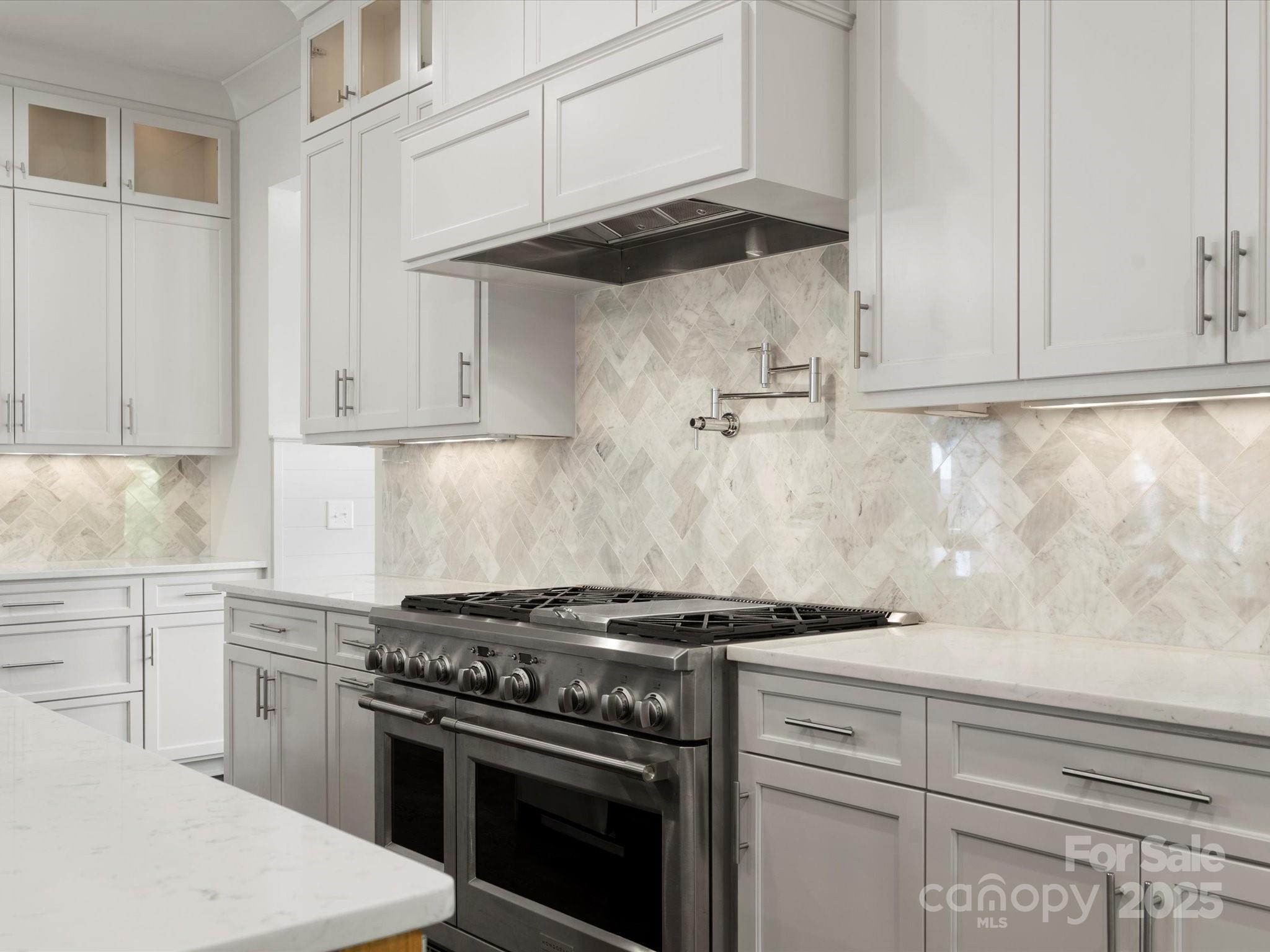 6700 Folger Drive Charlotte, NC 28270 - Photo 12 of 48 a kitchen with a stove and white cabinets