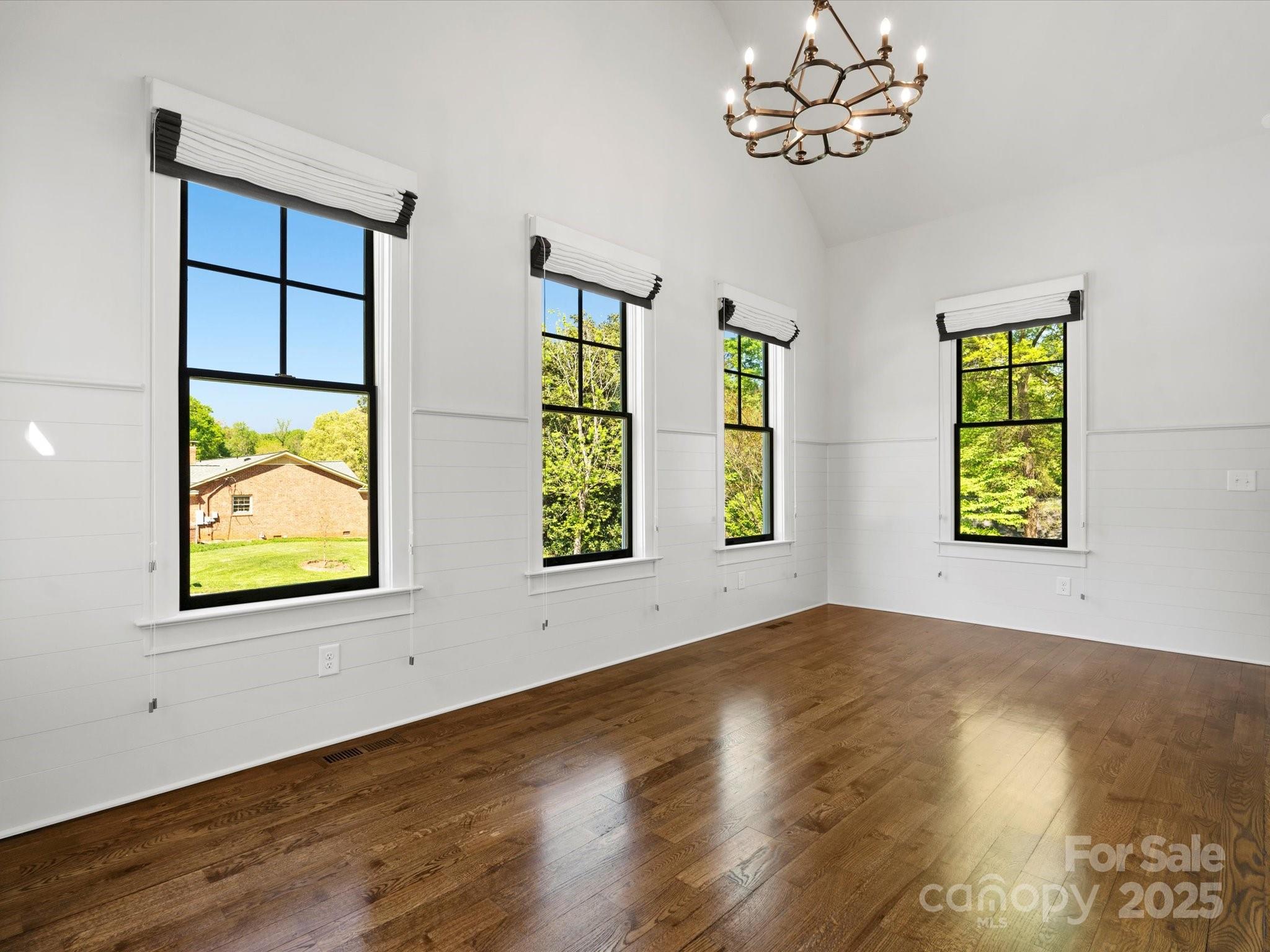 6700 Folger Drive Charlotte, NC 28270 - Photo 18 of 48 a view of an empty room with a window and wooden floor
