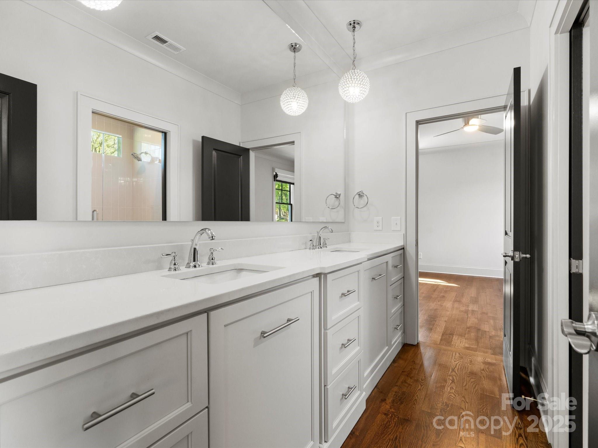 6700 Folger Drive Charlotte, NC 28270 - Photo 28 of 48 a spacious bathroom with a double vanity sink and a mirror