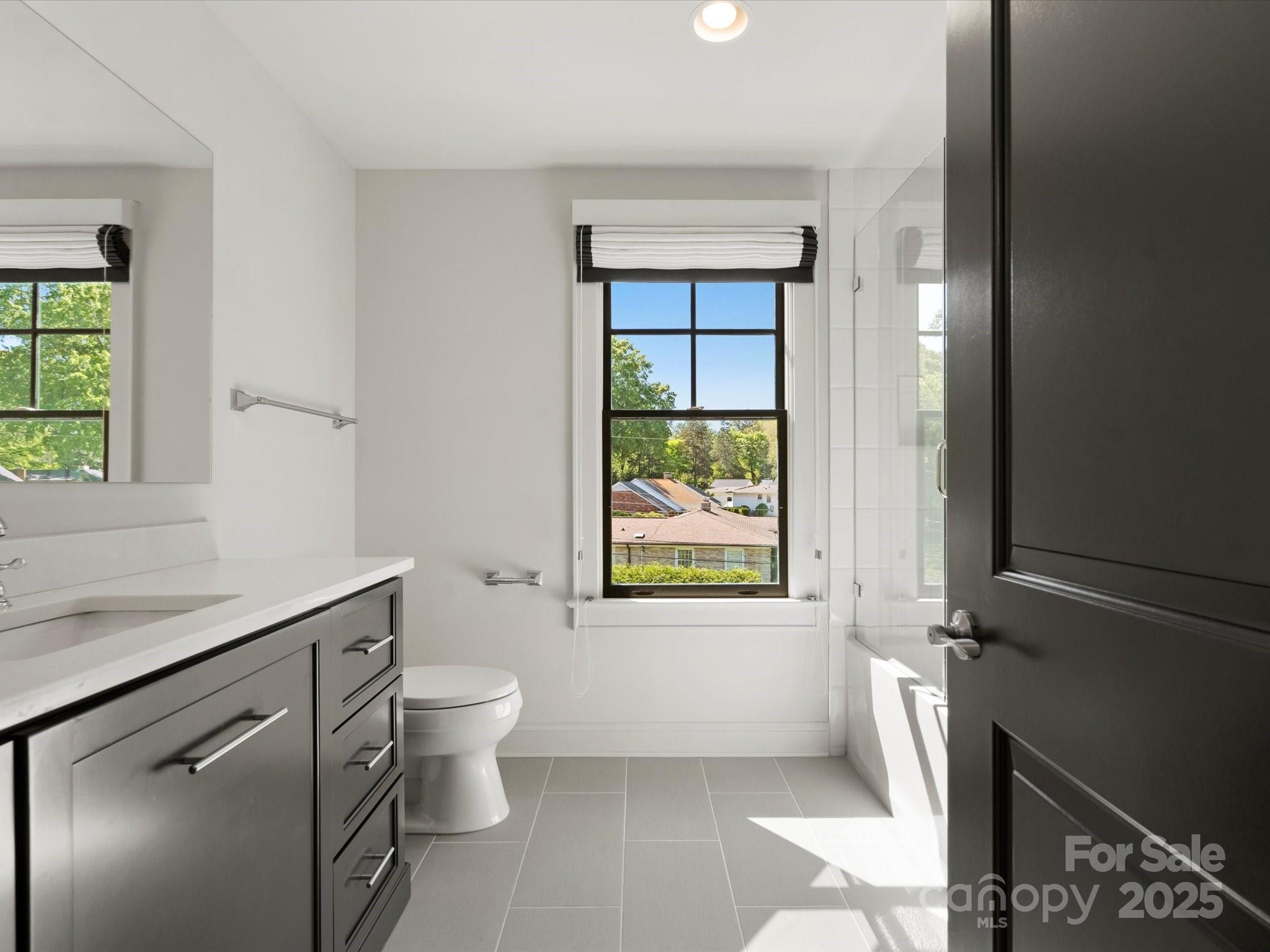 6700 Folger Drive Charlotte, NC 28270 - Photo 33 of 48 a bathroom with a granite countertop sink a toilet and a window