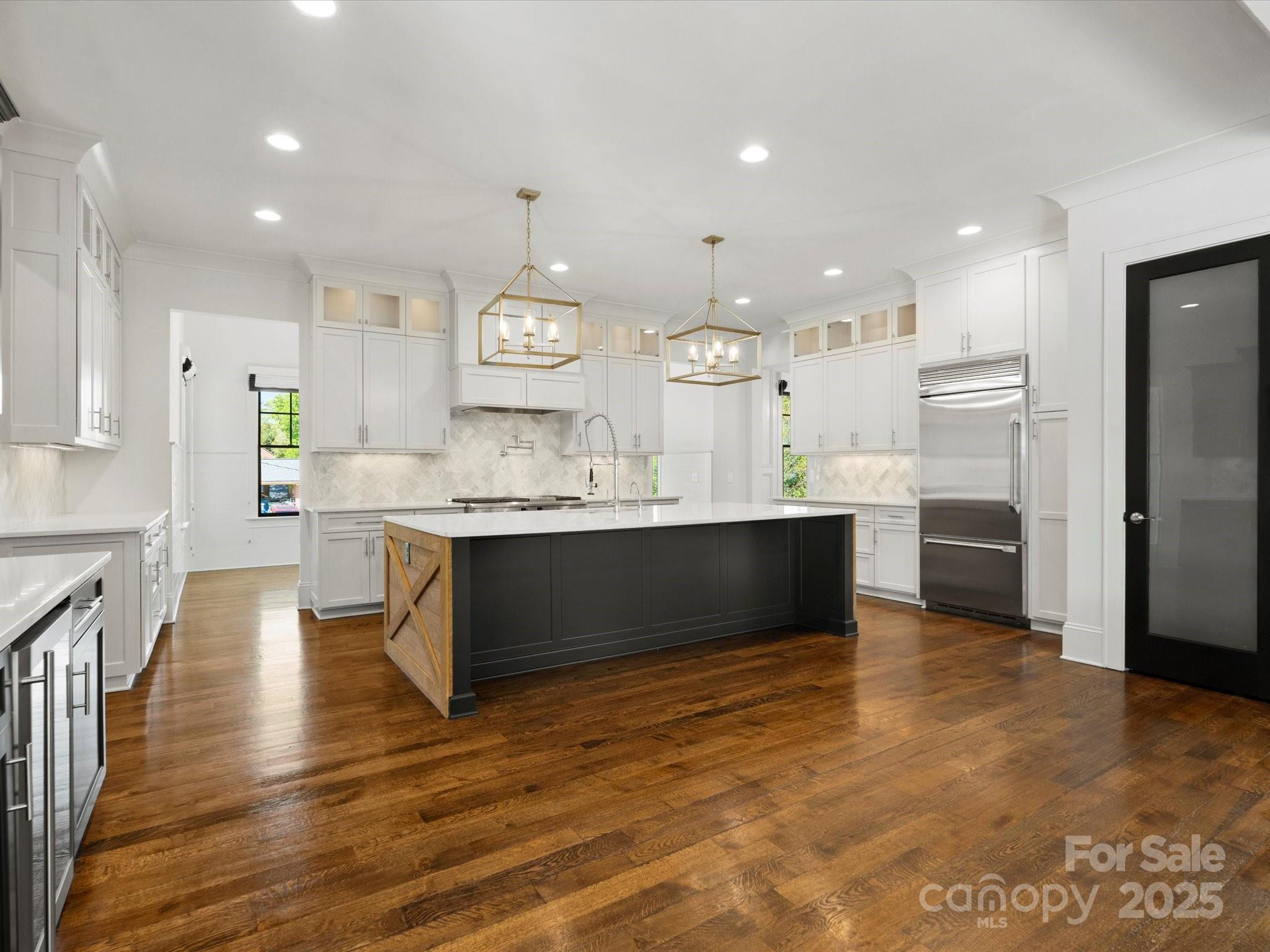 6700 Folger Drive Charlotte, NC 28270 - Photo 9 of 48 a large white kitchen with a large counter top a sink stainless steel appliances and cabinets