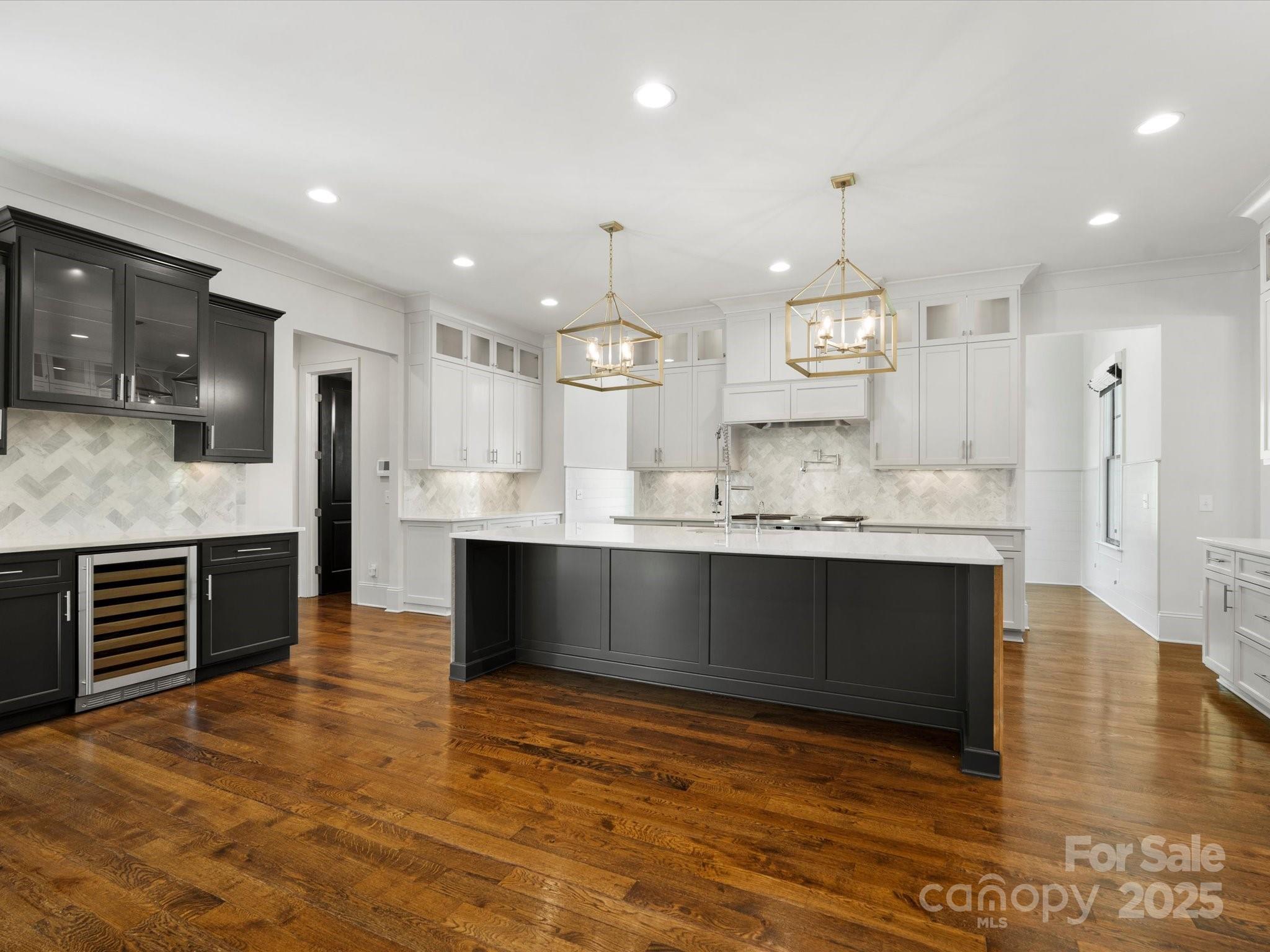 6700 Folger Drive Charlotte, NC 28270 - Photo 10 of 48 a large kitchen with kitchen island granite countertop a large counter top stainless steel appliances and cabinets