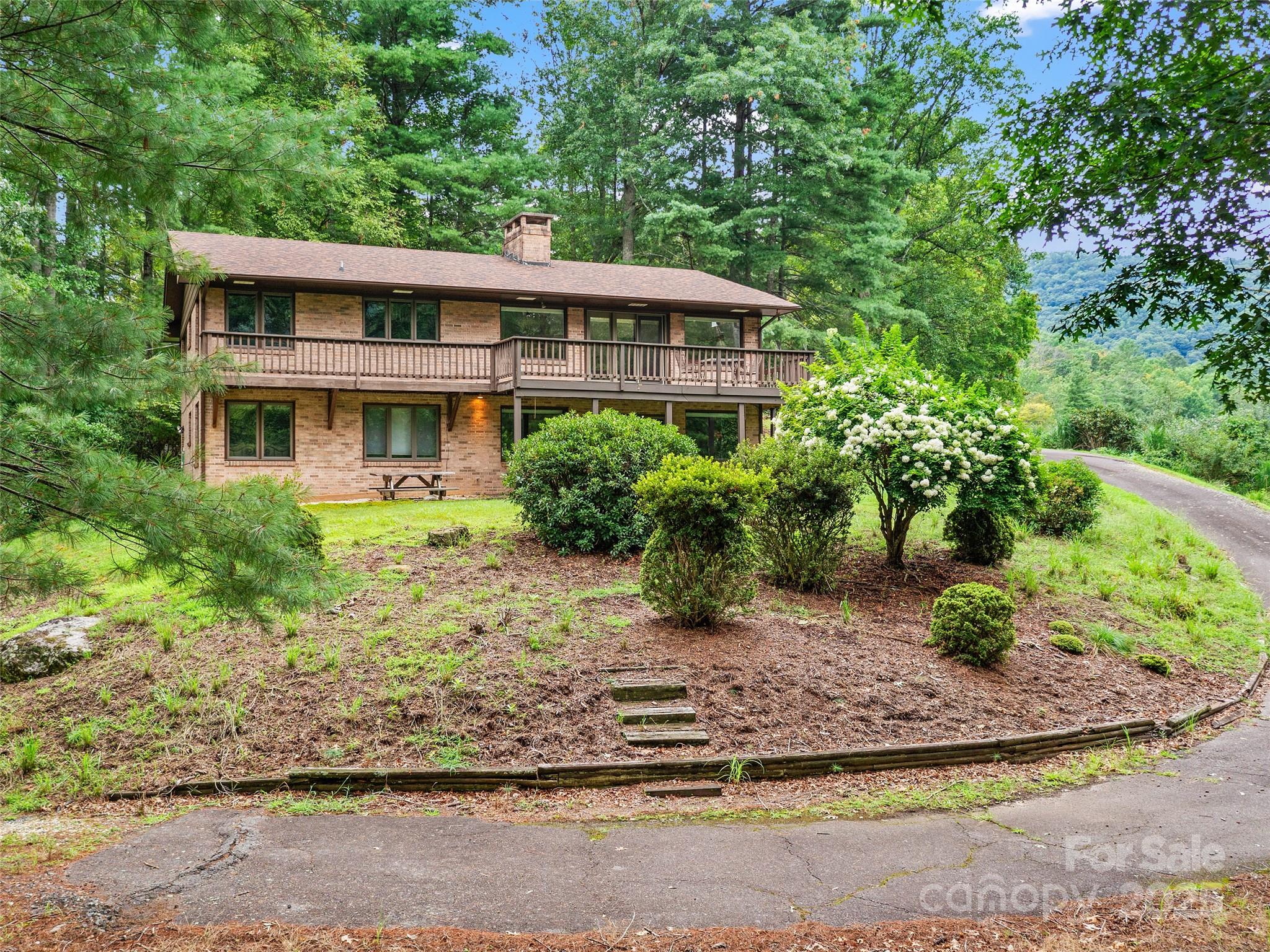 59 Deer Place Road Spruce Pine, NC 28777 - Photo 1 of 40 a view of a house with yard and plants