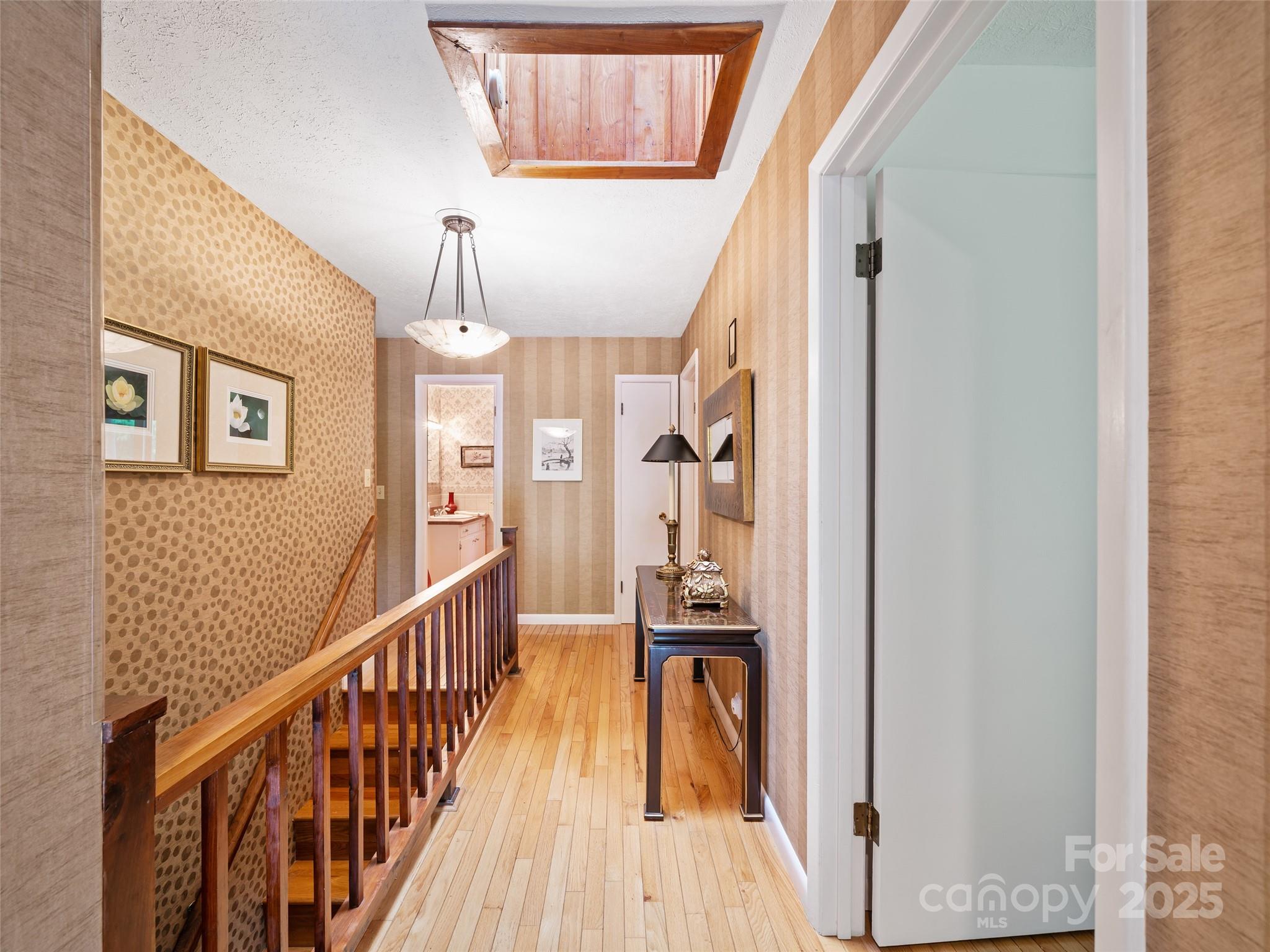 59 Deer Place Road Spruce Pine, NC 28777 - Photo 11 of 40 a view of a hallway with wooden floor and staircase